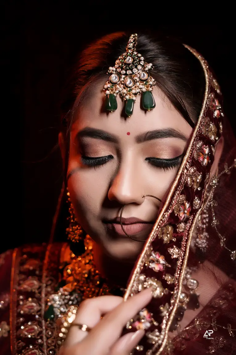 Bridal makeup with traditional red attire and jewelry